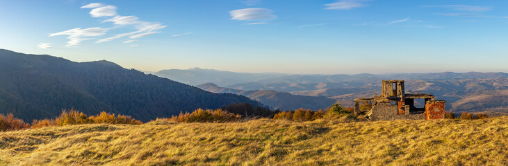 Fototapeta na wymiar Panorama of a mountainous area with the ruins of a building. Autumn in the Carpathian mountains
