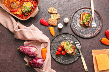Tasty baked vegetables on dark background