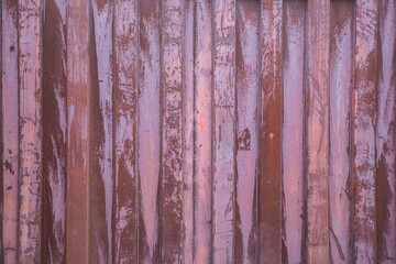 Industrial background. Rusty striped wall of metal container