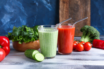 Glasses of healthy smoothie with vegetables on color background