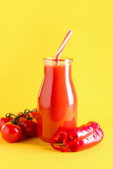 Bottle of healthy smoothie with tomato and bell pepper on color background