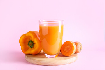 Glass of healthy smoothie with carrot and bell pepper on color background