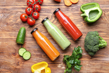 Composition with bottles of healthy smoothie on wooden background