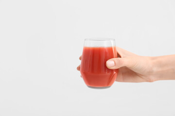 Hand with glass of healthy smoothie on white background