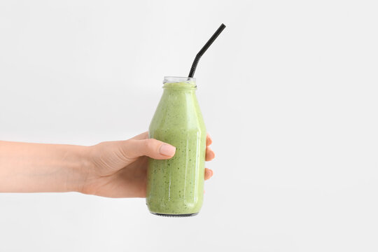 Hand With Bottle Of Healthy Smoothie On White Background