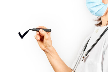 Doctor with mask drawing a checkup with a black marker pen