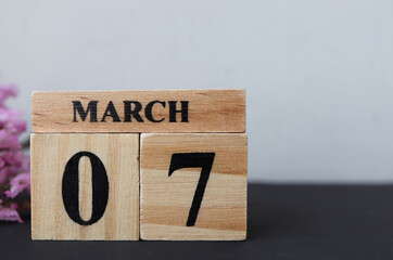 Day 7 of March month, Wooden calendar with date. Empty space for text.