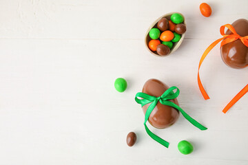 Chocolate Easter eggs on white wooden background