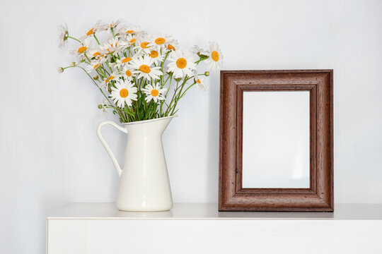 a bouquet of wild flowers on the table in a vase