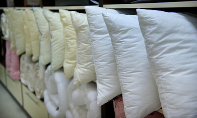 Fototapeta na wymiar Lots of soft down white pillows convenient for a pleasant sleep