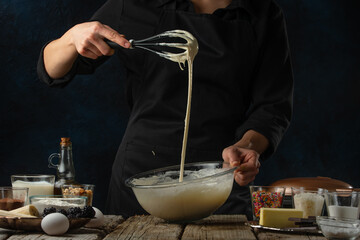 Chef prepares dough for sweet pastries, pancakes, waffles or punkies. Culinary recipes, ingredients. Recipe book, menu, cooking process