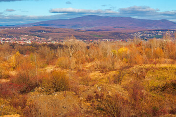 rural valley in the morning. beautiful autumn scenery in mountains. town in the distant valley. clouds on the blue forenoon sky