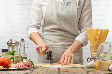 Chef cuts dough for making pizza or italian pasta.Culinary recipes, cooking