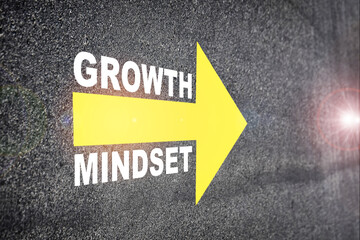Growth mindset with yellow arrow marking on road surface. Self development to success concept and challenge idea