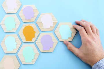 wooden blocks with people icon over blue background, building a strong team, human resources and...