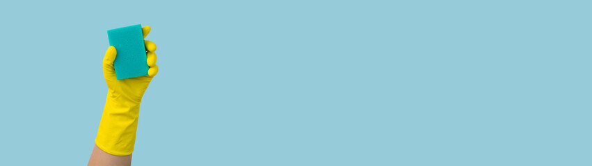 Hand in yellow glove with sponge banner with copy space: cleaning concept