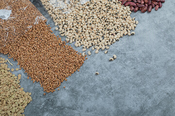 Different kinds of beans packed on a gray background