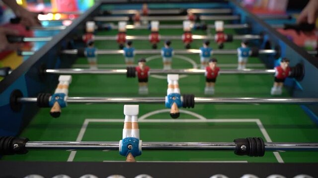 Foosball. Hands of a man playing table football