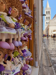 Croatian traditional souvenir lavender dolly on street of old town of Zadar with cathedral bell...