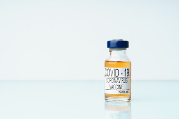 Covid 19 corona virus vaccine vial for intramuscular injection on medical table with copy space.