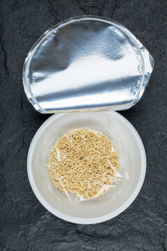 Unprepared yummy noodles own a dark background