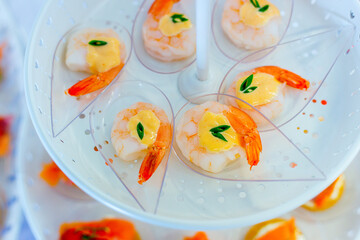 shrimp with sauce on Plastic spoon, appetizer 