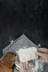 Woman hand holding a slice of bread with flour