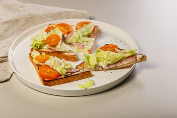 Homemade toast with beef, ice salad and tomatoes. Delicious and healthy breakfast. Quick lunch. Organic food.