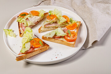 Tasty toast with beef, ice salad and tomatoes. Delicious and healthy breakfast. Snack. Organic food.