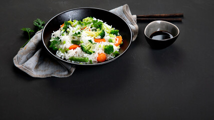Healthy vegan rice with boiled broccoli, carrot and spring onion