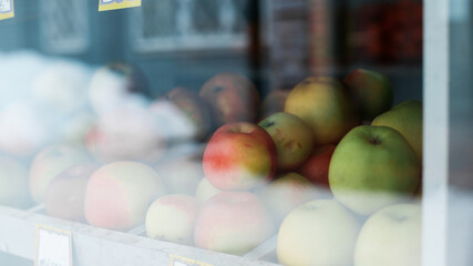 Red, green apples on a shop window. Selective focus