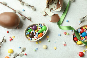 Fototapeta na wymiar Easter concept with chocolate eggs on white textured background
