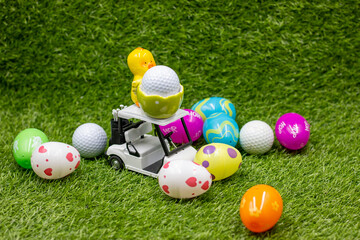 Golf ball with Easter eggs on green grass for Easter Holiday 