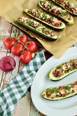 Zucchini boat filled with ground beef, mushroom, tomato sauce and parmesan cheese. Garnish with chopped parsley