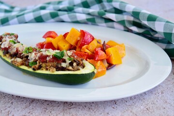 Zucchini boat filled with ground beef, mushroom, tomato sauce and parmesan cheese. Garnish with chopped parsley