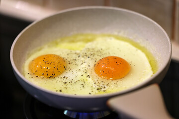 Frying pan with fried egg sprinkled with dill