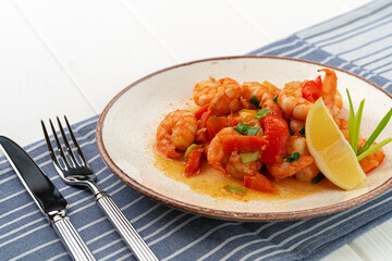 Stir fried seafood with sauce on plate with napkin