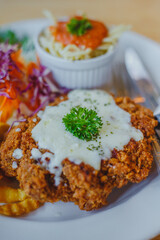 Fried pork chop, French fries and vegetables