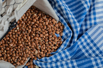 Raw brown kidney beans on a tablecloth