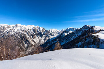 Snow capped mountains in winter of the Monte Carega, called the small Dolomites seen from the Altopiano della Lessinia (Lessinia High Plateau). Veneto and Trentino Alto Adige, Italy, Europe.