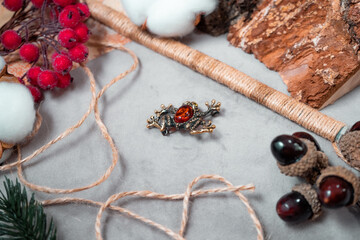 A brooch in the form of a frog made of bronze and amber