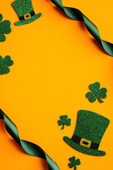 St Patricks Day vertical banner design. Top view of shamrock leaves, leprechauns hats, green ribbon...