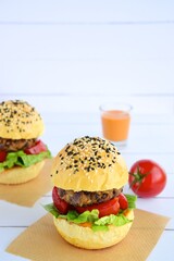 Vegetarian burger. Sesame bread bun with lentil patty, tomato, lettuce and yogurt