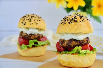 Vegetarian burger. Sesame bread bun with lentil patty, tomato, lettuce and yogurt