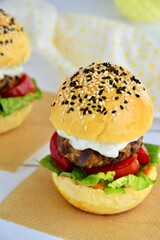 Vegetarian burger. Sesame bread bun with lentil patty, tomato, lettuce and yogurt