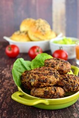 Beluga lentil rice patties with vegetarian burger on the background
