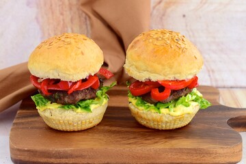 homemade beef burger with red bell peppers, lettuce and curry mayonnaise sauce
