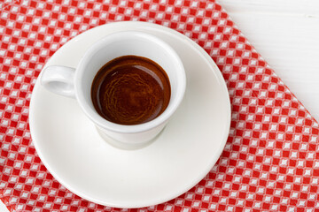 Cup of espresso coffee on saucer close up