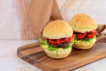 homemade beef burger with red bell peppers, lettuce and curry mayonnaise sauce
