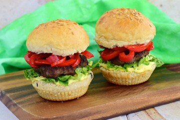 homemade beef burger with red bell peppers, lettuce and curry mayonnaise sauce
